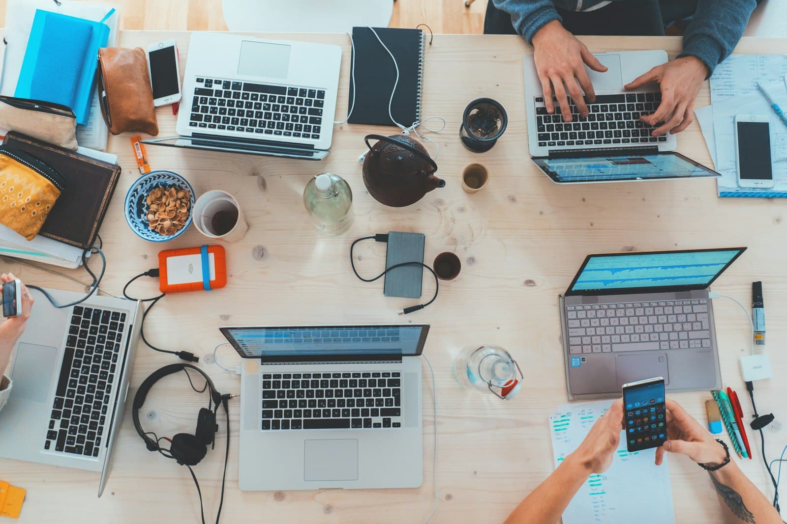 A team working on laptops around a table